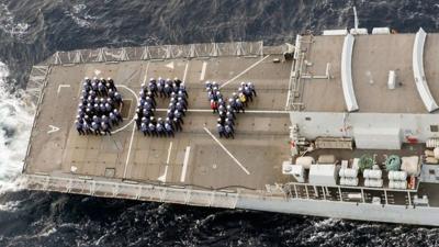 HMS Lancaster's crew spell out the word "boy"