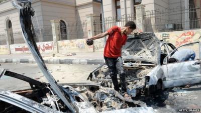 Child on burnt out cars