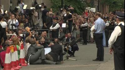 Journalists sat on the floor to keep out of shot