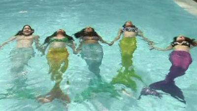 Women and girls wear mono-tails and swim like mermaids