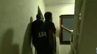 Police taking part in the dawn raids