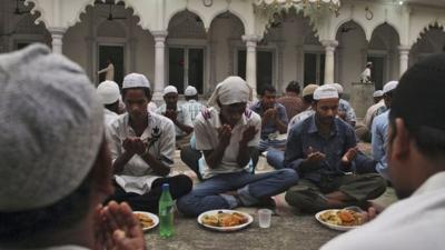 Indian Muslims offer prayers before breaking fast during the holy month of Ramadan