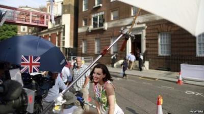 A television reporter speak to the camera opposite the Lindo Wing of St Mary"s Hospital, where Catherine, Duchess of Cambridge has been admitted to give birth, in London