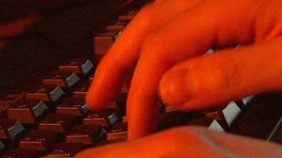 Hands typing on a keyboard