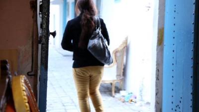 Woman leaving shop in Bizerte