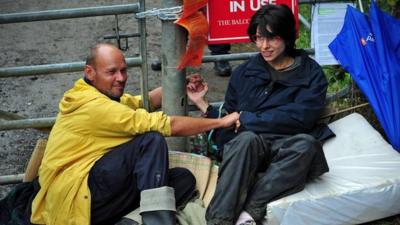 Two protesters with hands glued together