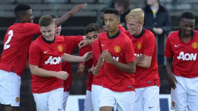 Manchester United celebrate victory over Strikers FC at the Milk Cup