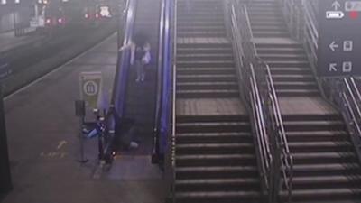 CCTV of man falling down escalator at Leeds station