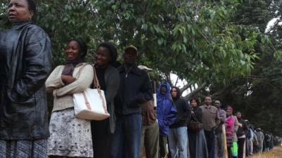 A queue of voters wait to cast their ballots as the country went to the polls in a Harare suburb Wednesday 31 July 2013