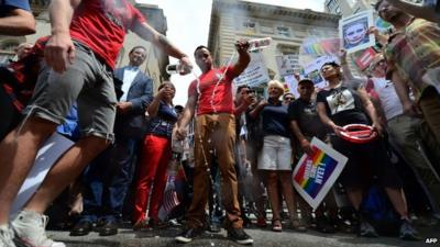 Protesters pouring Russian vodka onto street outside Russian consulate in New York