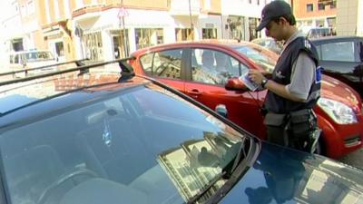 Traffic warden issuing a parking ticket