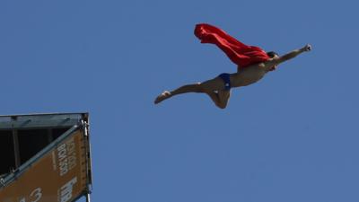 Michal Navratil diving in a red cape