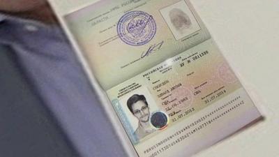 Anatoly Kucherena held up Snowden's passport to show journalists the asylum stamp granted by Russia