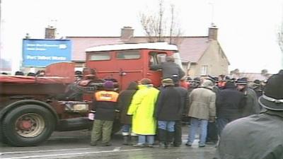 Police and striking miners surround a lorry