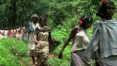 Women walk through threatened area