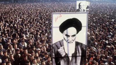 Iranian protesters hold a up a poster of Ayatollah Ruhollah Khomeini during a demonstration in Tehran