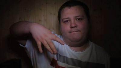 Rapper flashes a hand signal