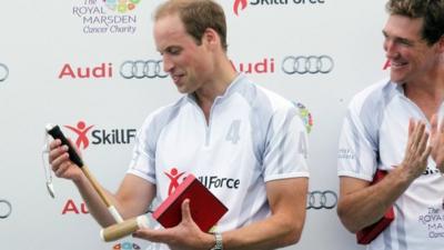 Prince William being presented with a child's polo mallet