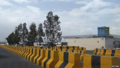 A car drives past the British embassy in Sanaa August 3, 2013