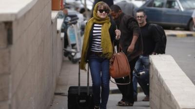 Travellers walk to the departure lounge at Sanaa International Airport