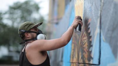 A graffiti artist spraying paint