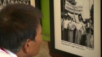 Student looks at Myanmar uprising photo