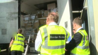 Border Force officials check a lorry