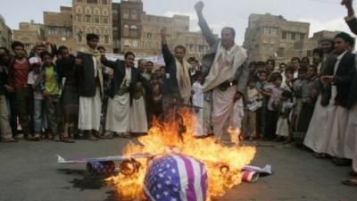 Protesters burn an effigy of a US aircraft after Friday prayers in Sanaa, Yemen, on 12 April 2013