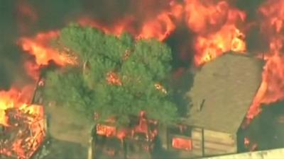 Aerial view of a house engulfed by fire