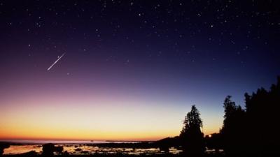 Shooting star in night sky