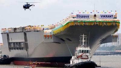 Tugboats guide INS Vikrant