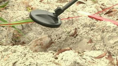 Metal detector over unexploded bomb