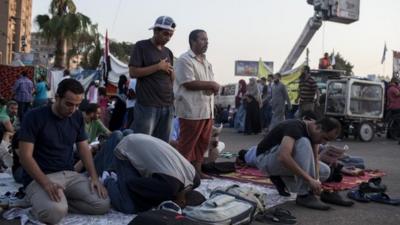 Supporters of deposed Egyptian President Mohammed Morsi perform morning prayer