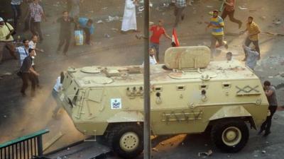 Supporters of ousted Islamist President Mohammed Morsi capture an Egyptian security forces vehicle at the Ministry of Finance in Cairo, Egypt