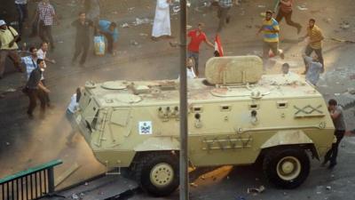 Supporters of ousted Islamist President Mohammed Morsi capture an Egyptian security forces vehicle at the Ministry of Finance in Cairo, Egypt