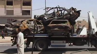 Burnt-out vehicles in Baghdad