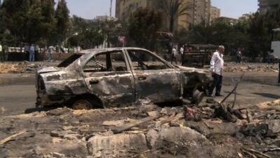 Burnt-out car at Rabaa al-Adawiya