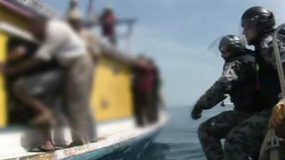 Australian authorities alongside an asylum boat