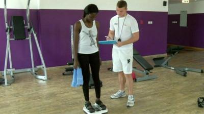 Woman on scales in gym