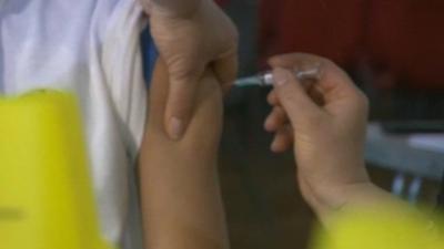 Child being vaccinated with MMR jab