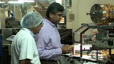 Ajay Chauhan examines biscuits in factory