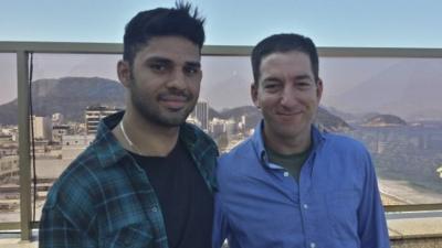 In this undated photo released by Janine Gibson of The Guardian, Guardian journalist Glenn Greenwald, right, and his partner David Miranda, are shown together at an unknown location