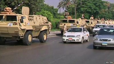 Egyptian military and cars on a road