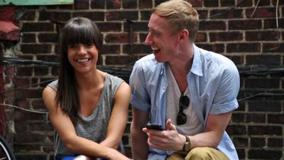 Jessie and Tim pose for a photograph while laughing