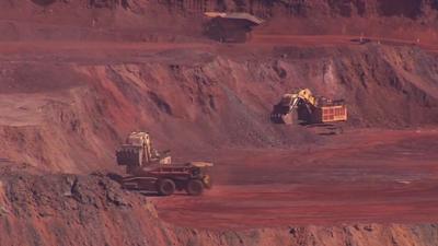 A red and brown rocky terrain being mined for metal