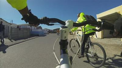 Sizwe Nzima and a colleague riding their bicycles