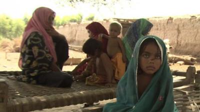 A family in flooded area of Pakistan