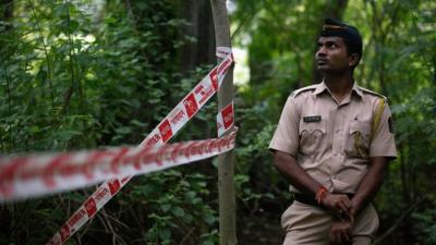 Policeman standing guard at crime scene