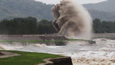 A tidal wave hits a bank along the Qiantang River in Haining, China