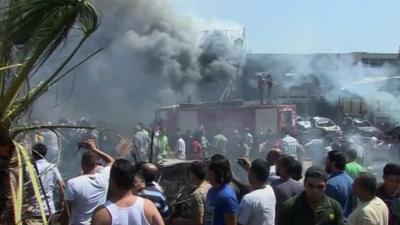 Smoke and emergency vehicles in Tripoli in the aftermath of the blasts